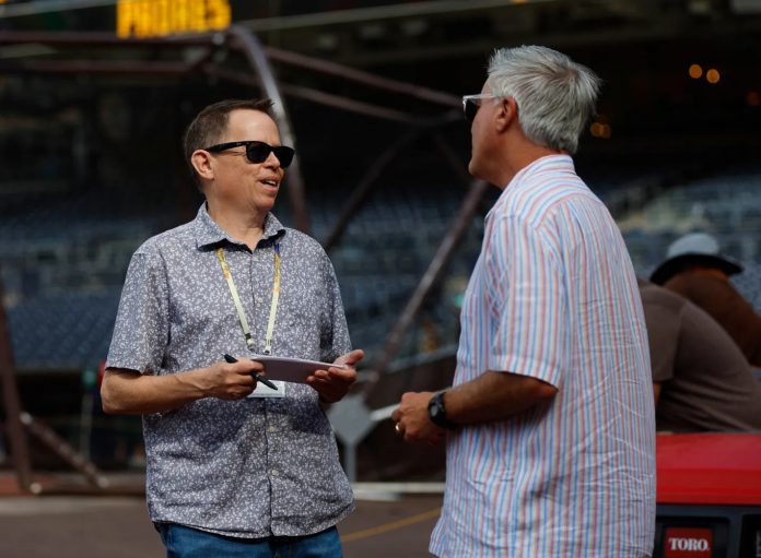 San Diego Union-Tribune columnist Bryce Miller talks with fellow writer Scott Miller before the San Diego Padres played the Baltimore Orioles at Petco Park on Tuesday, Aug. 15, 2023 (K.C. Alfred / The San Diego Union-Tribune)