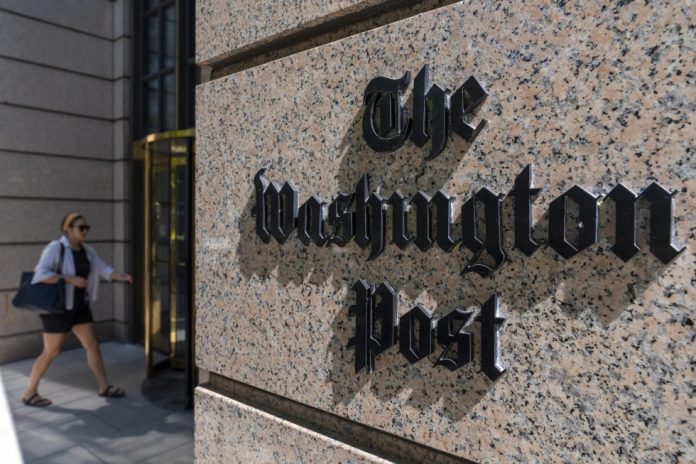 A person walks into the One Franklin Square Building, home of The Washington Post newspaper, Friday, June 21, 2024, in Washington. (AP Photo/Alex Brandon, File)