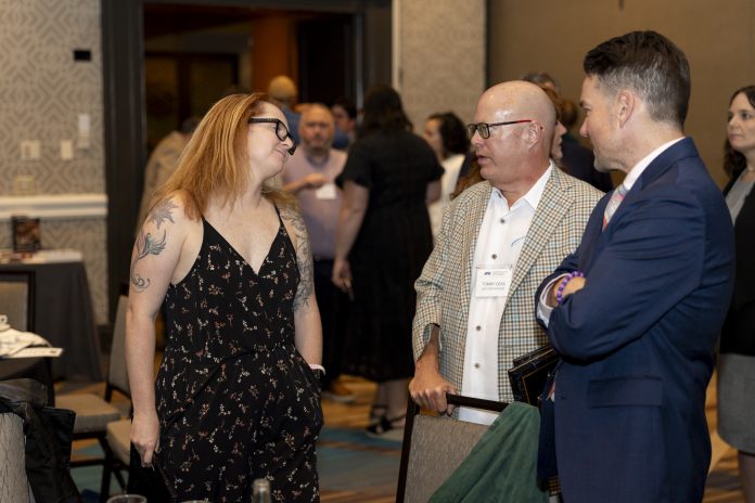 Amie Just of the Lincoln Journal Star, Tommy Deas of the USA Today Network, and Austin Hertzog of PennLive talk at the Associated Press Sports Editors Summer Conference Awards Banquet at the Crystal Gateway Marriot in Arlington, Virginia, on Saturday, July 18, 2026. (Photo by Austin DeSisto)