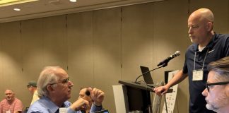 APSE opens 2026 Summer Conference with record sponsorship, membership gains Former APSE president Mike Sherman speaks with current APSE president Paul Barrett and first vice president Perryn Keys at the opening meeting in Arlington, Virginia, on July 16, 2026.