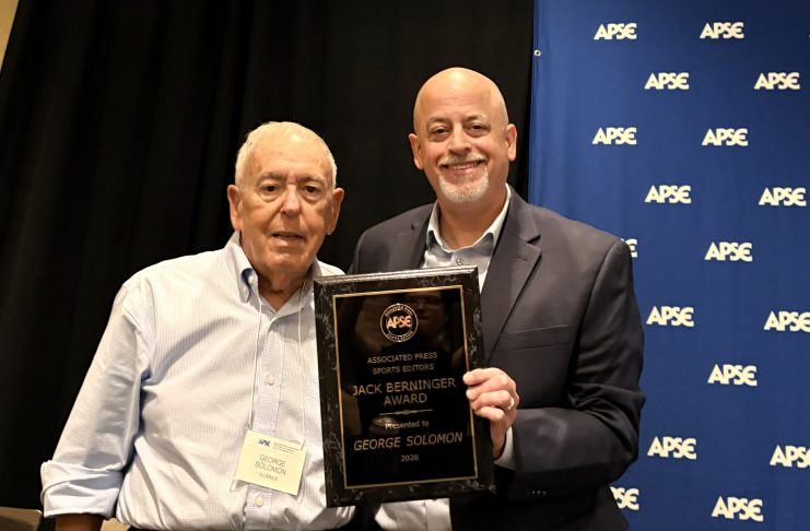 George Solomon earns standing ovation, Jack Berninger Award at APSE George Solomon receives the Jack Berninger Award from APSE President Paul Barrett during the APSE Summer Conference in Arlington, Virginia, on Friday, July 17, 2026. (Photo by Maria McIlwain)